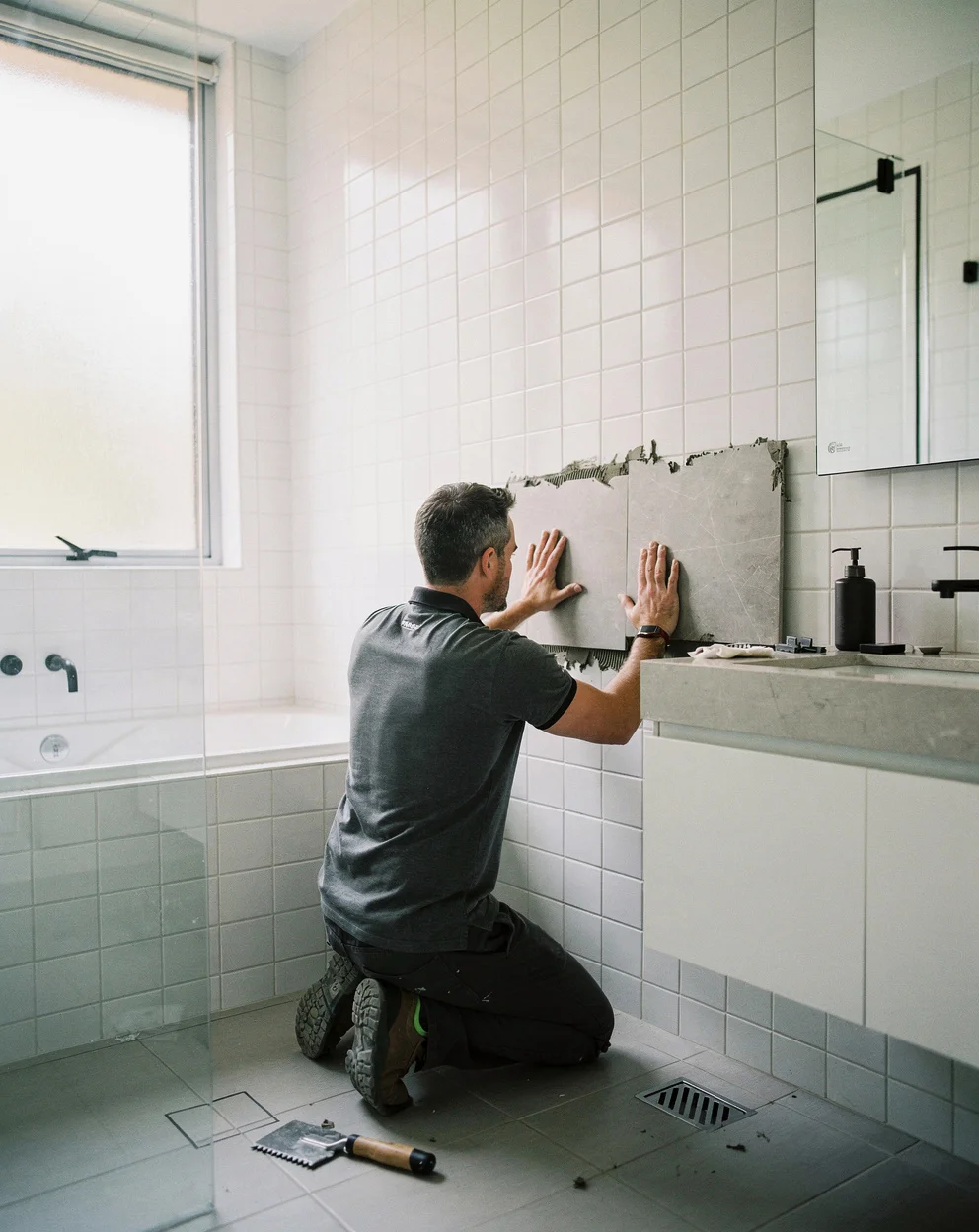 A premium Sydney bathroom built by Bathline, full-height tiles and a stone vanity